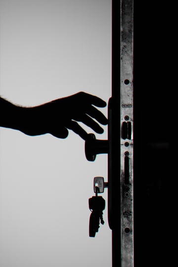 silhouette-photo-of-person-holding-door-knob-792032