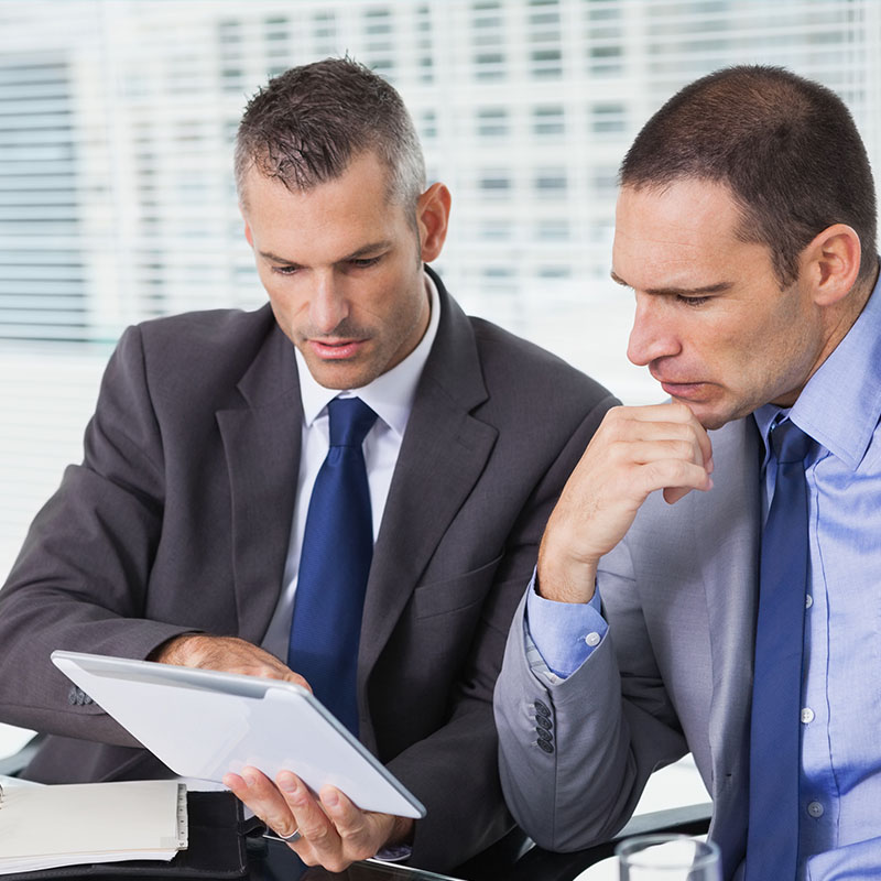 businessmen-reviewing-doc businessmen-reviewing-doc